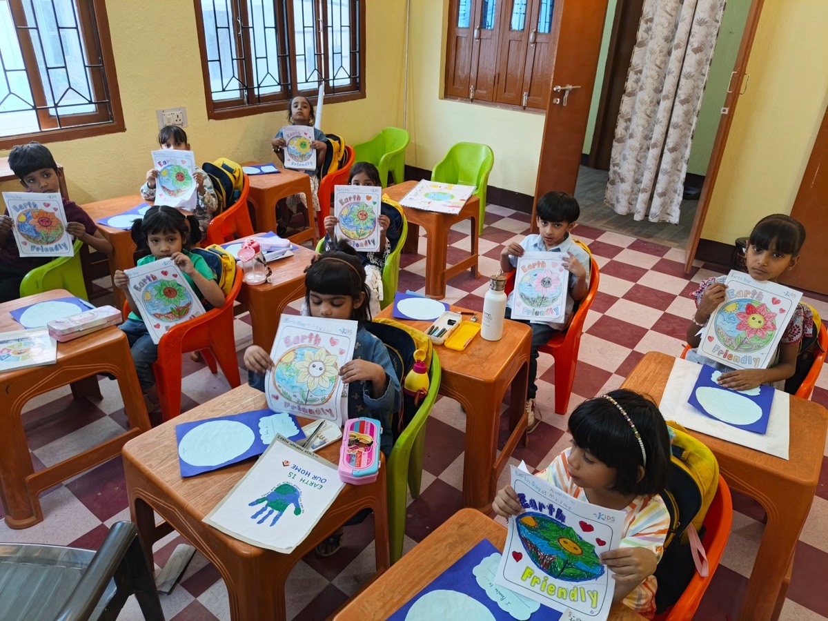 Children at their desks showing Earth Friendly posters they have coloured