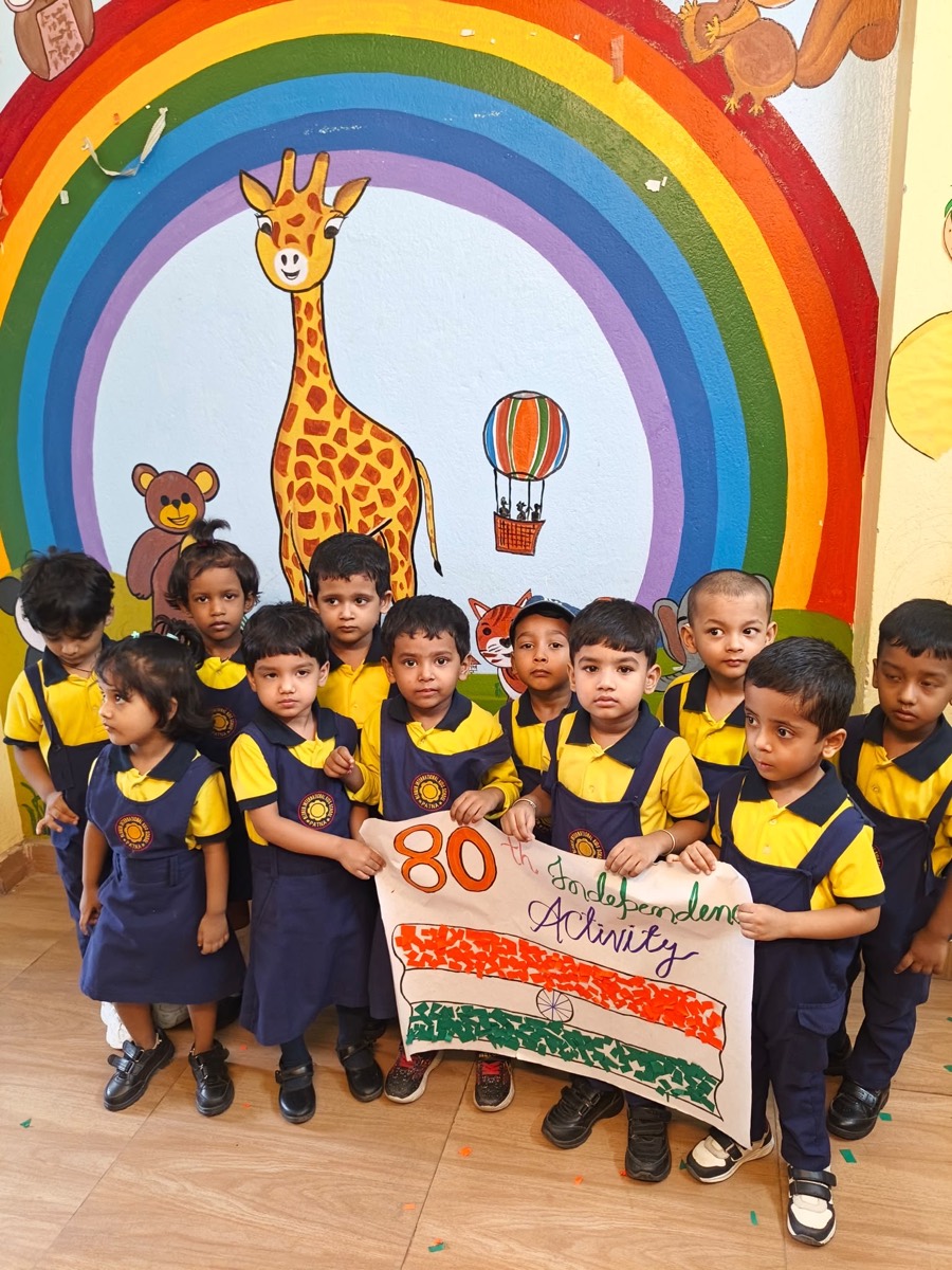 Children holding a hand-made banner for the 80th Independence Day activity