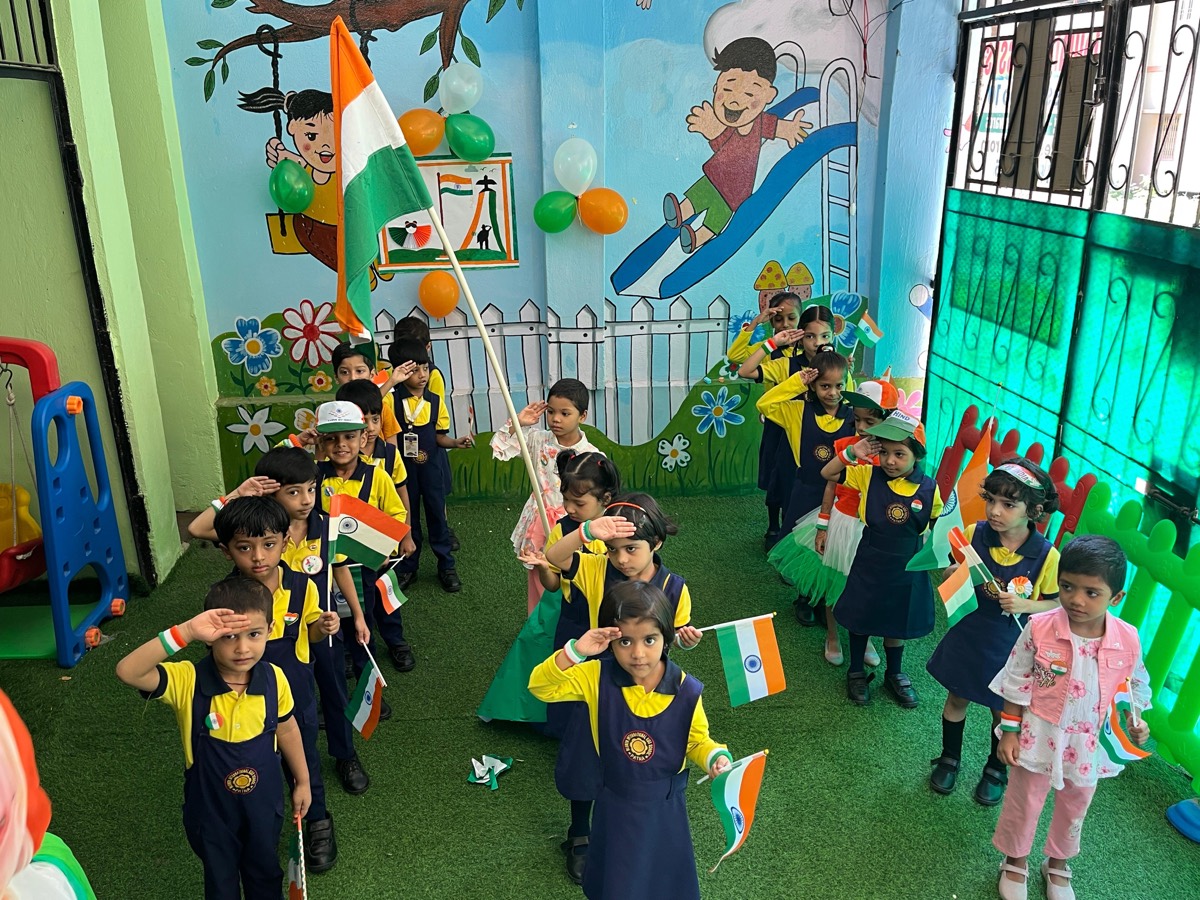 Children saluting with Indian flags at the Independence Day ceremony